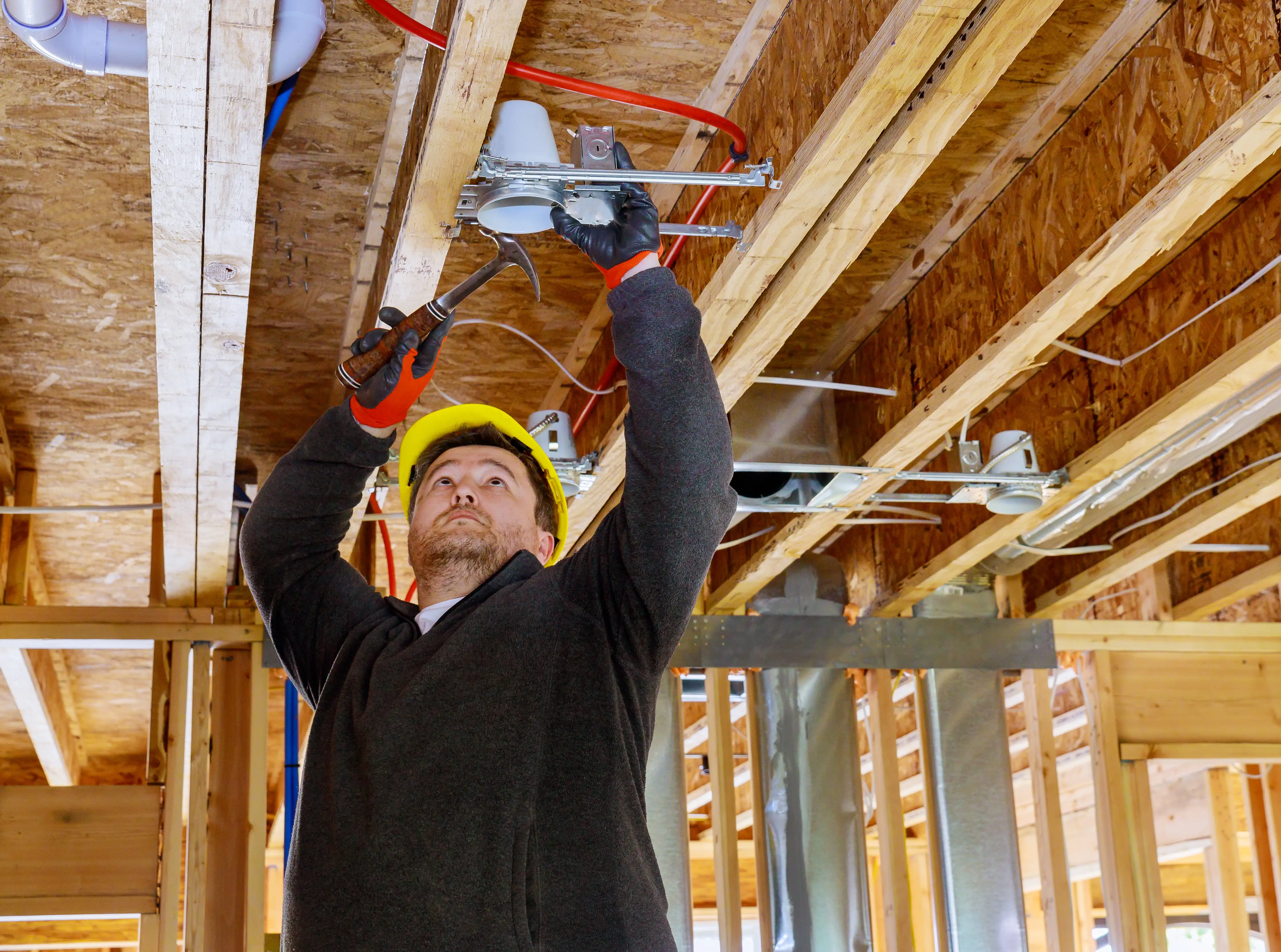 Electrician working on a consumer unit and wiring